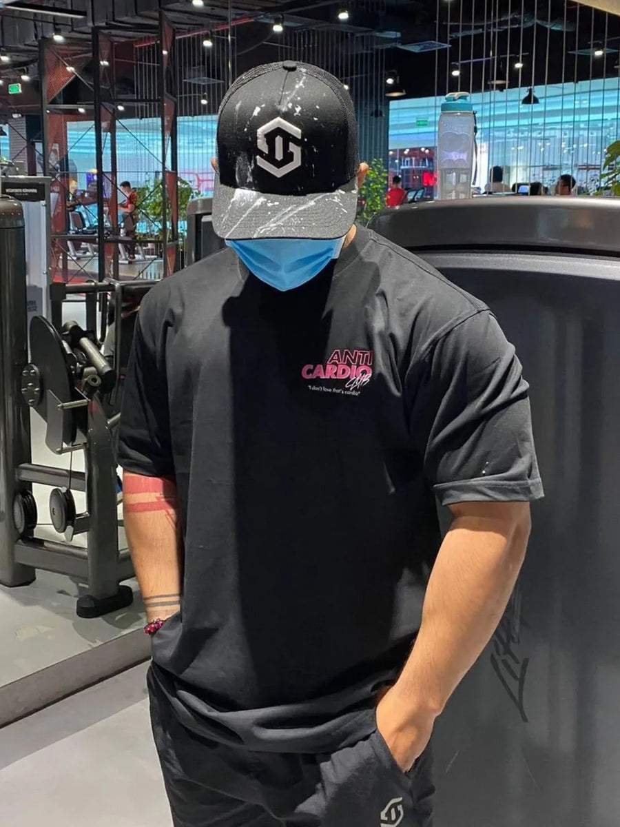 Black graphic t-shirt with pink "Anti Cardio Club" text and a small white tagline.