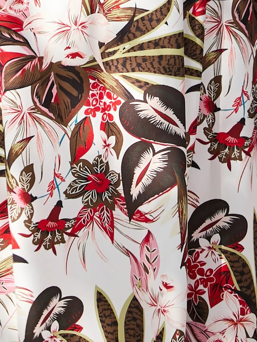 Chic floral midi dress with spaghetti straps in white with a vibrant tropical print.