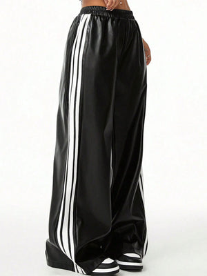 Black faux leather wide leg track pants with white side stripes and elastic waistband.