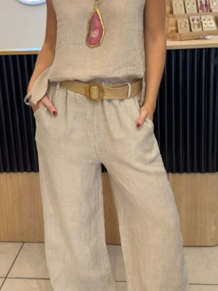 Relaxed fit tank and wide-leg pants set in apricot, featuring a straw belt and a statement necklace.