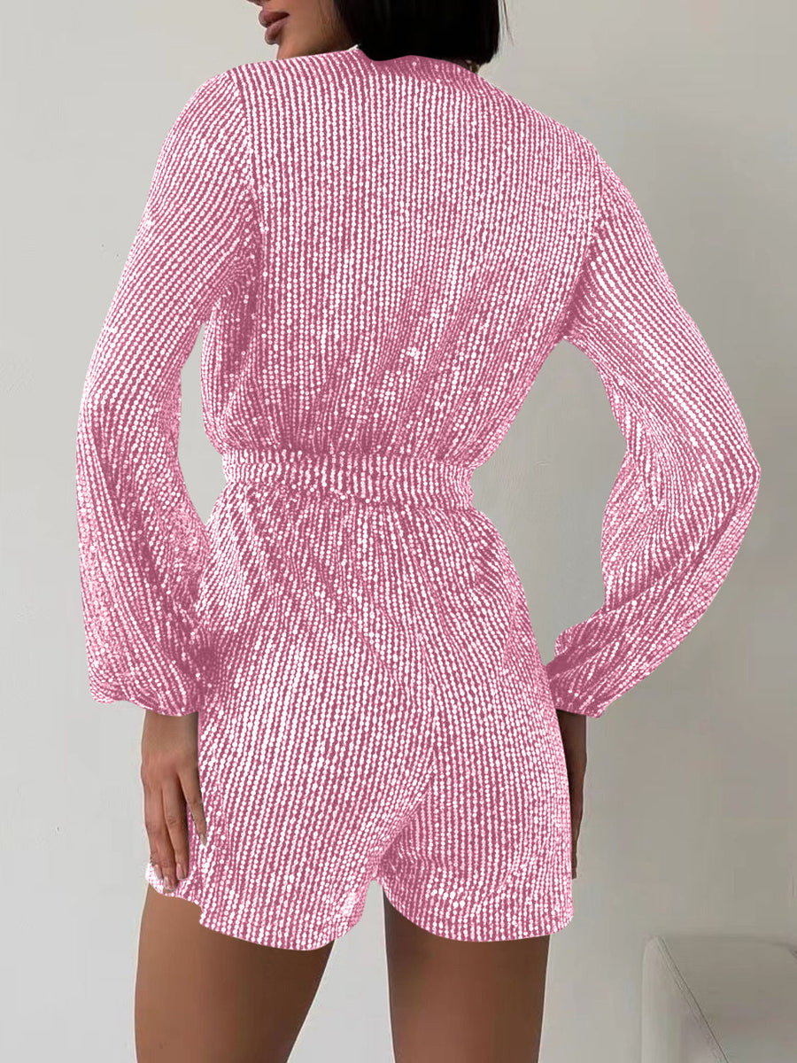 Pink sequin wrap romper with blouson sleeves and cinched waist