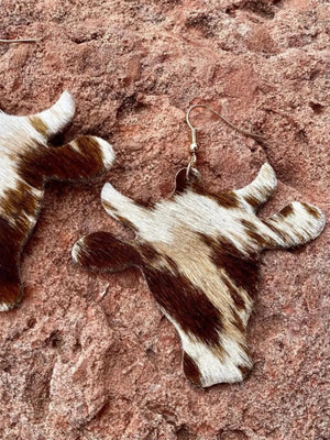 Cowhide silhouette drop earrings in brown and white, featuring a bull head design.