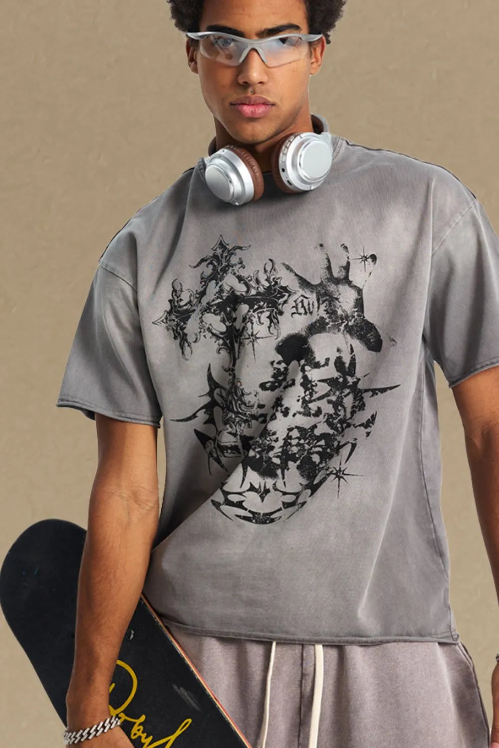 Gray distressed graphic tee with raw hem and abstract black print.