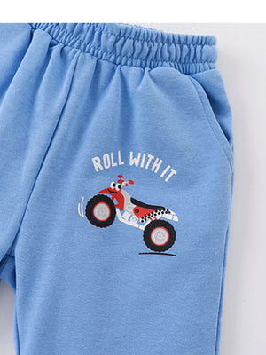 Blue toddler shorts with ATV print and "Roll With It" text.