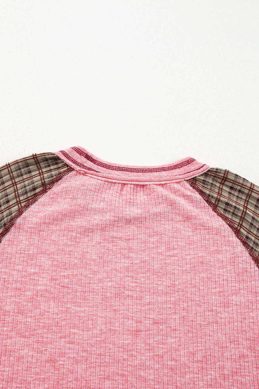 Pink raglan tee with plaid sleeves and a ribbed texture.