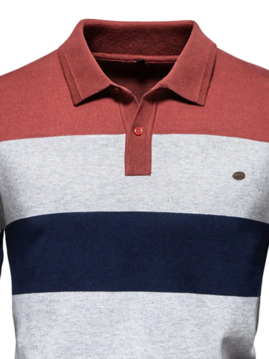 Colorblock knit polo shirt with ribbed collar in coral, gray, and navy stripes.