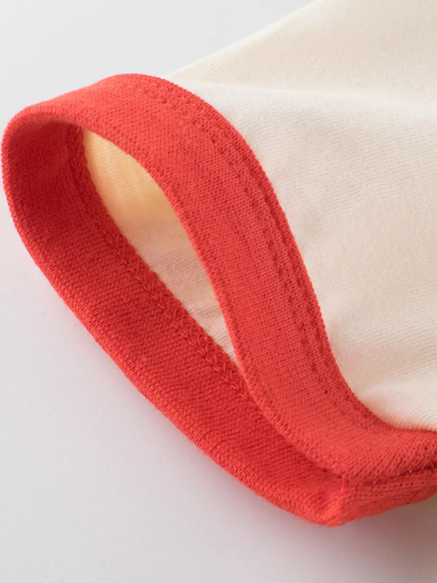 Cream t-shirt with red contrast trim.