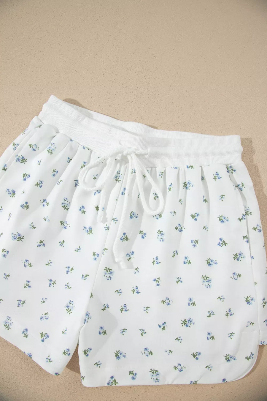 White floral print shorts with drawstring waist and elastic band