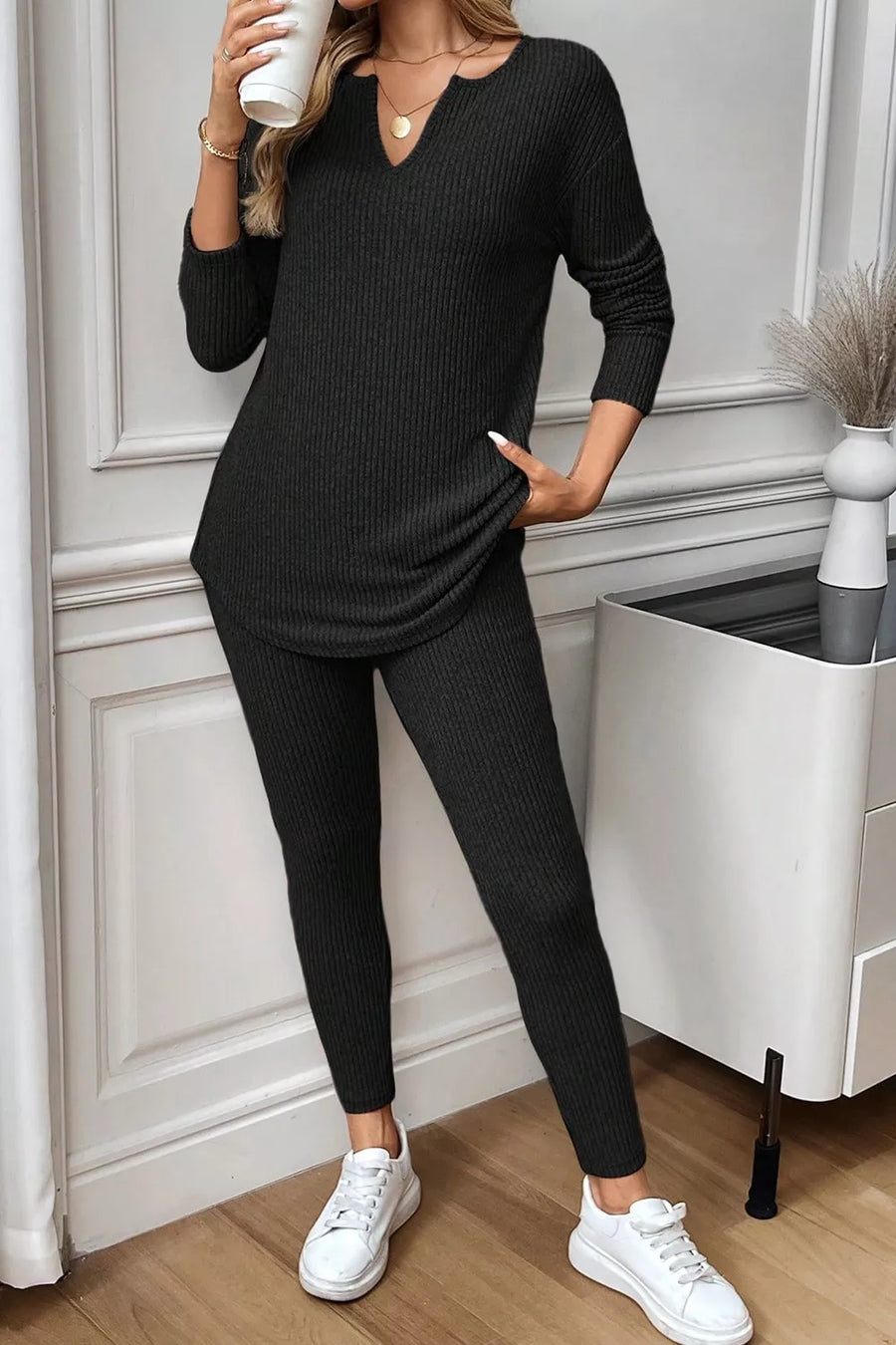 Black ribbed loungewear set with notched V-neck long sleeve top and leggings.