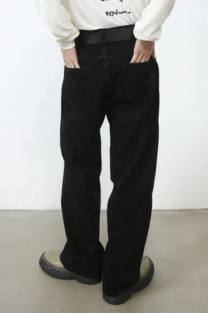 Dark denim trousers with sculpted seams and a relaxed fit.