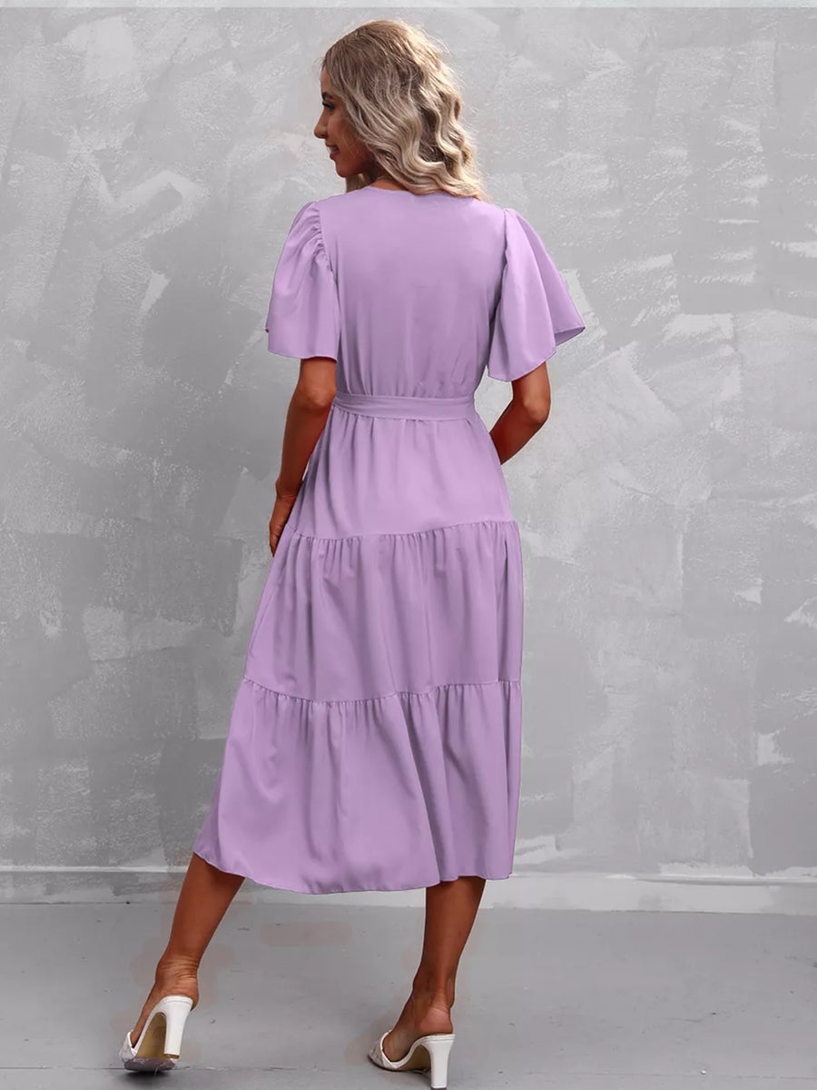 Lavender tiered midi dress with flutter sleeves and belted waist.