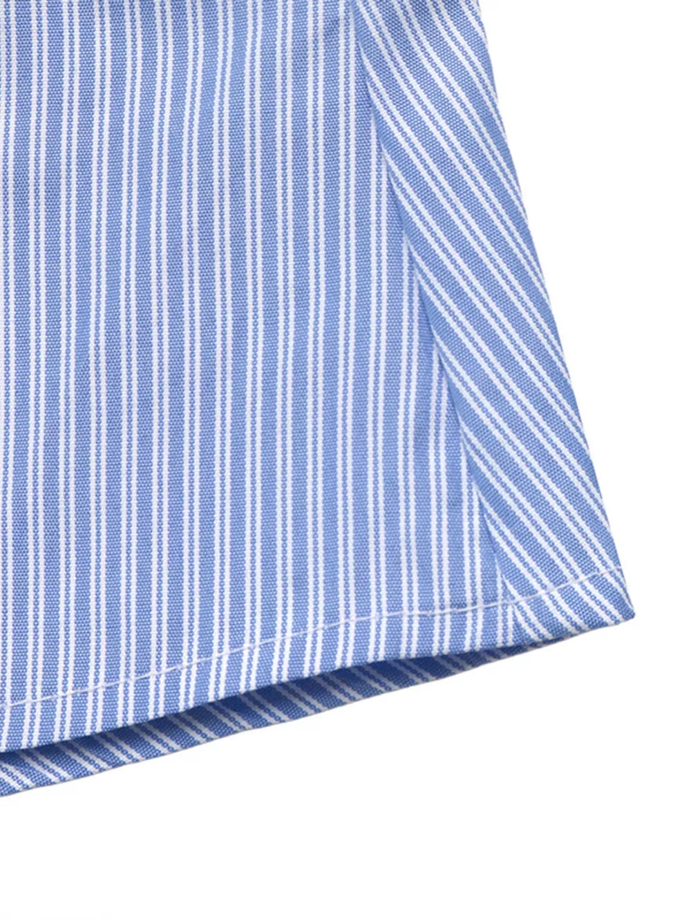 button-down shirt in light blue with button cuffs and hip-length