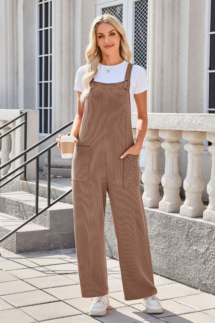Striped caramel corduroy overalls with patch pockets and wide legs.
