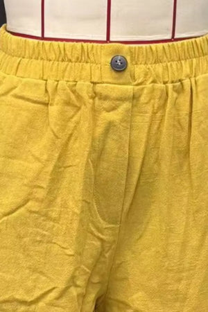 Mustard yellow linen-blend shorts with elastic waist and button closure.