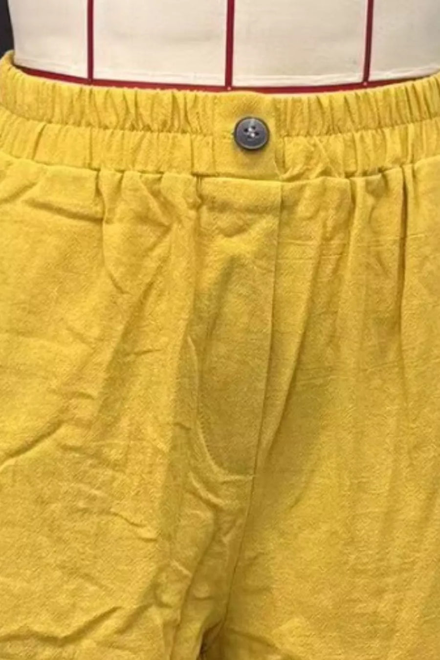 Mustard yellow linen-blend shorts with elastic waist and button closure.