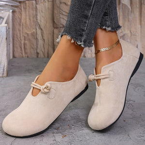 Beige matte fabric round toe flats with decorative cord detail.
