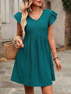 Peacock blue a-line dress with ruffled sleeves and textured fabric.