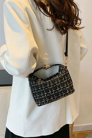 Black tweed box bag with gold hardware and detachable strap styled with a white blazer