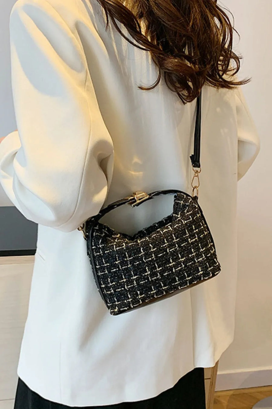 Black tweed box bag with gold hardware and detachable strap styled with a white blazer