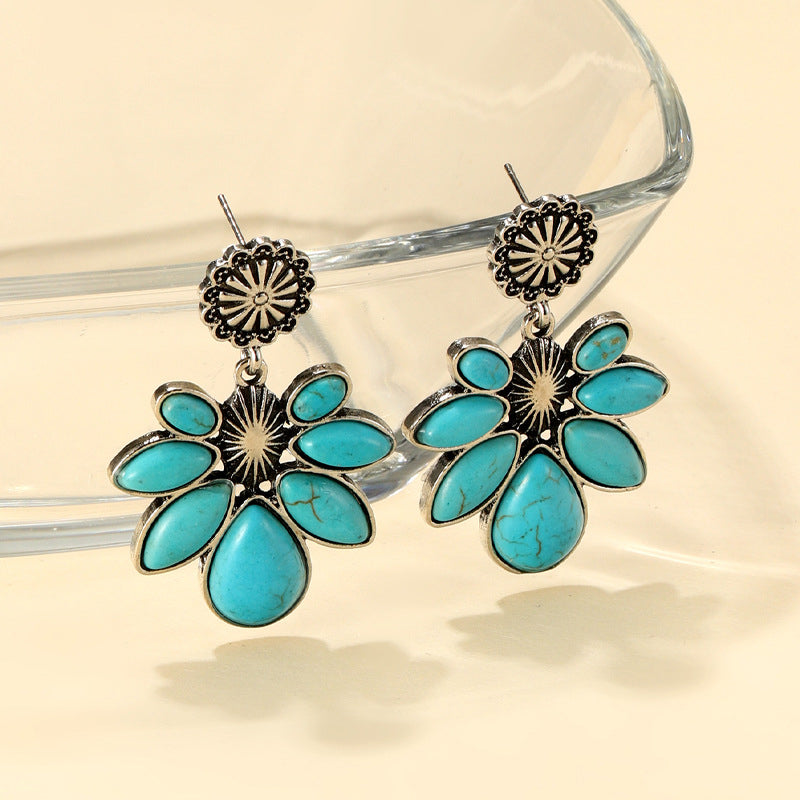 Teal floral petal drop earrings with alloy metal and artificial turquoise stones.