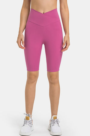 V-waist pocketed performance biker shorts in hot pink with side pockets.