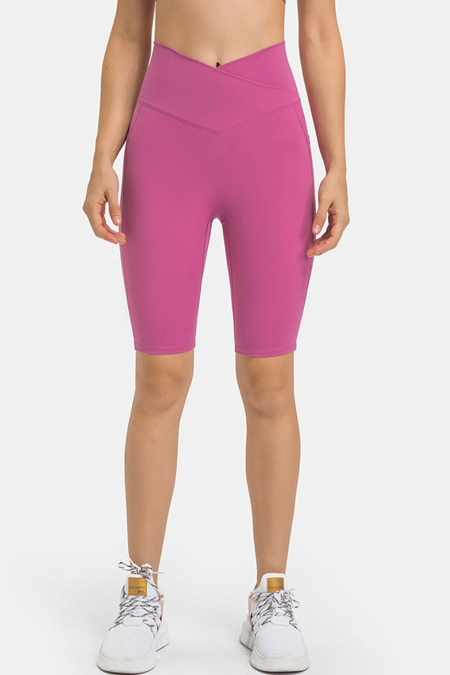 V-waist pocketed performance biker shorts in hot pink with side pockets.