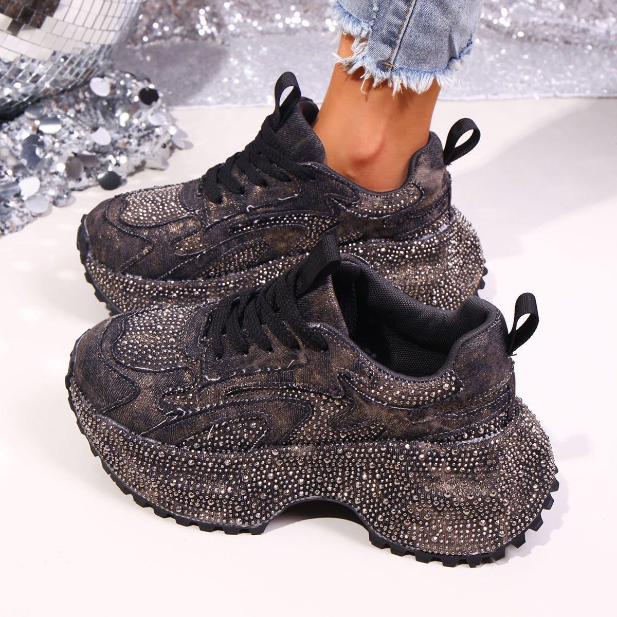 Black rhinestone high-heel platform sneakers with chunky soles.