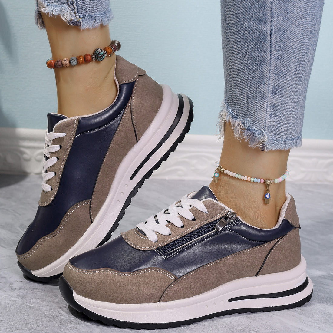Zipper detail lace up sneakers in navy and taupe with a chunky sole.