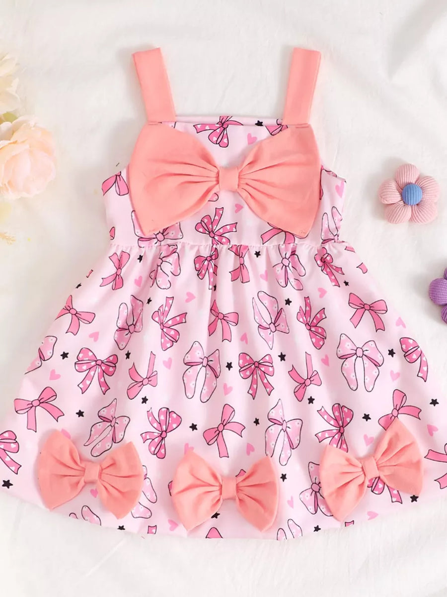 Pink baby dress with bow print and large bow detail, cotton fabric.