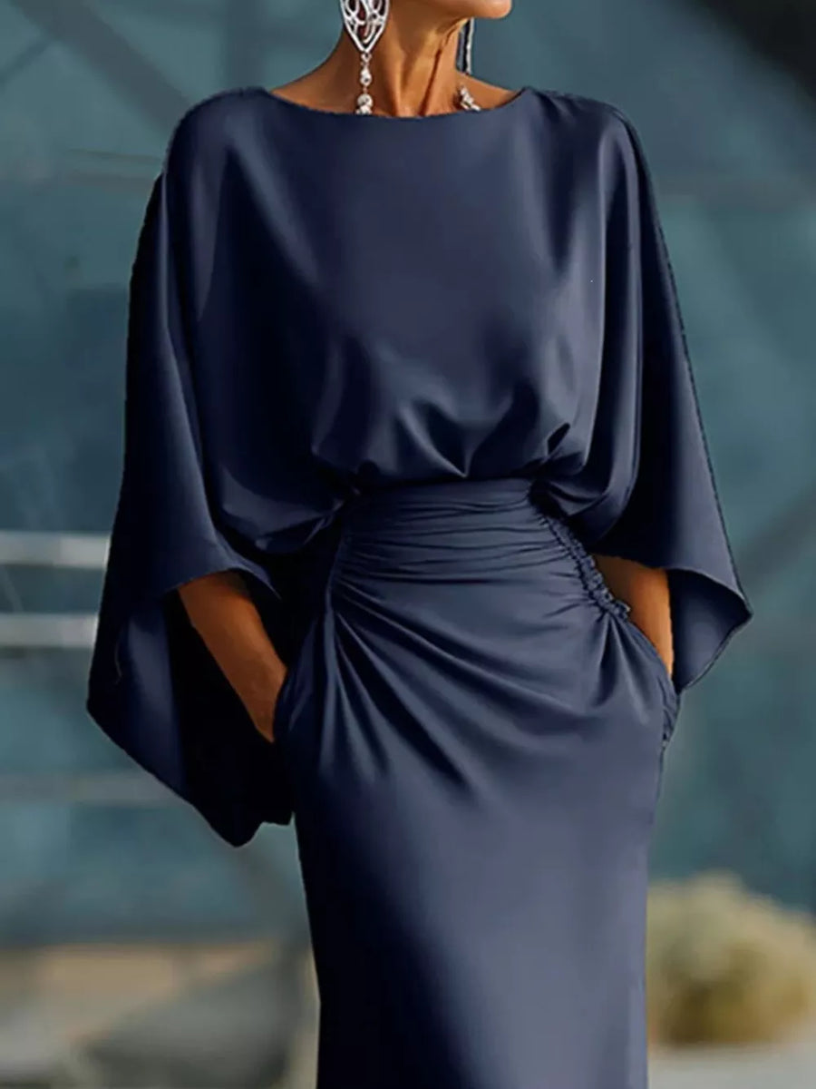 Navy batwing sleeve maxi dress with cinched waist and pockets.