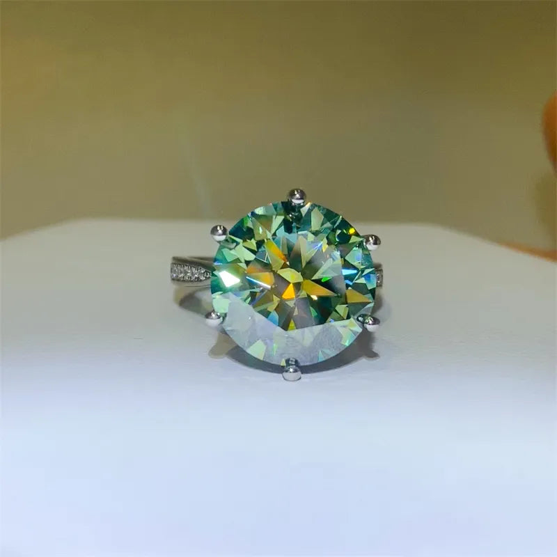 Silver ring with large, bright green prismatic cut solitaire diamond and pavé band.