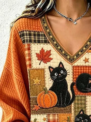 beige v-neck sweater featuring v-neck and patchwork