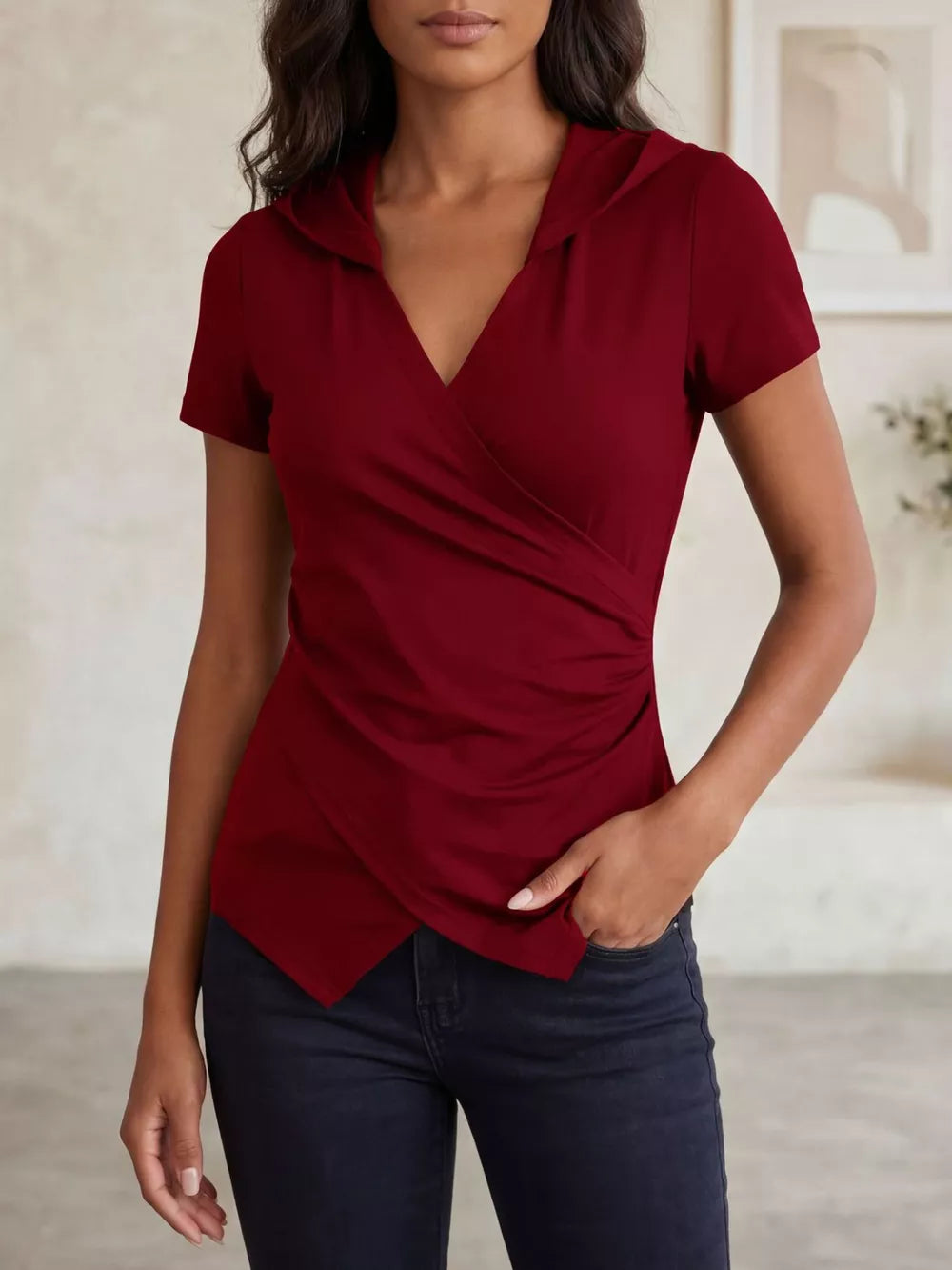 Red ruched hooded slim fit t-shirt with asymmetrical wrap front and short sleeves.