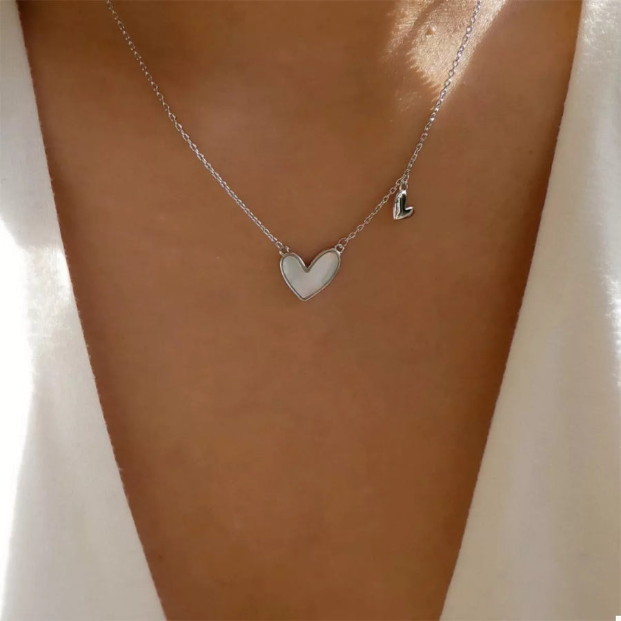 Silver heart pendant necklace with a smaller heart charm on a delicate chain