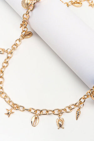 Gold chain belt with seashell, starfish, turtle, and conch charms.
