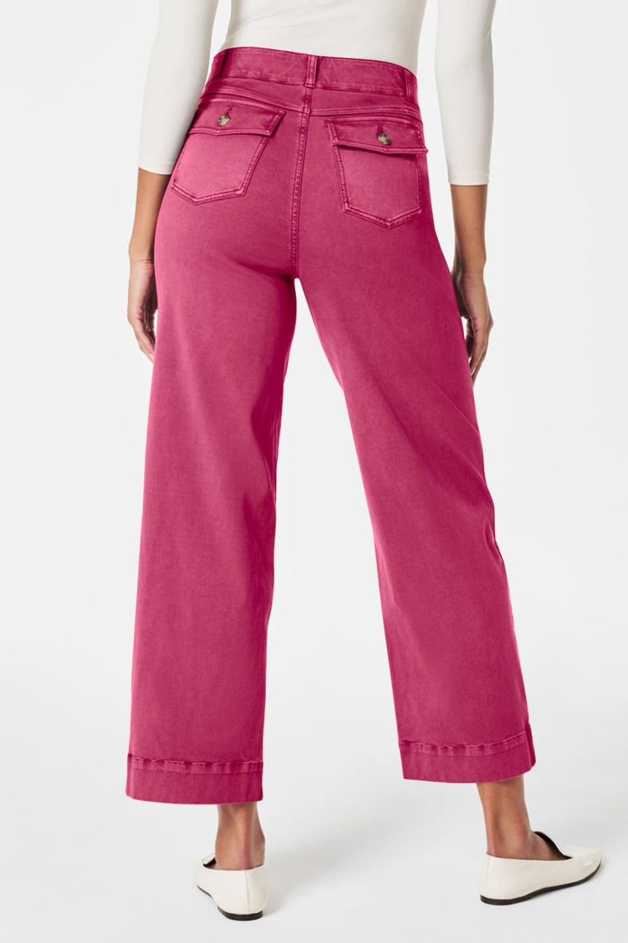 Wide-leg denim trousers in fuchsia pink with buttoned back pockets and a cropped hem.