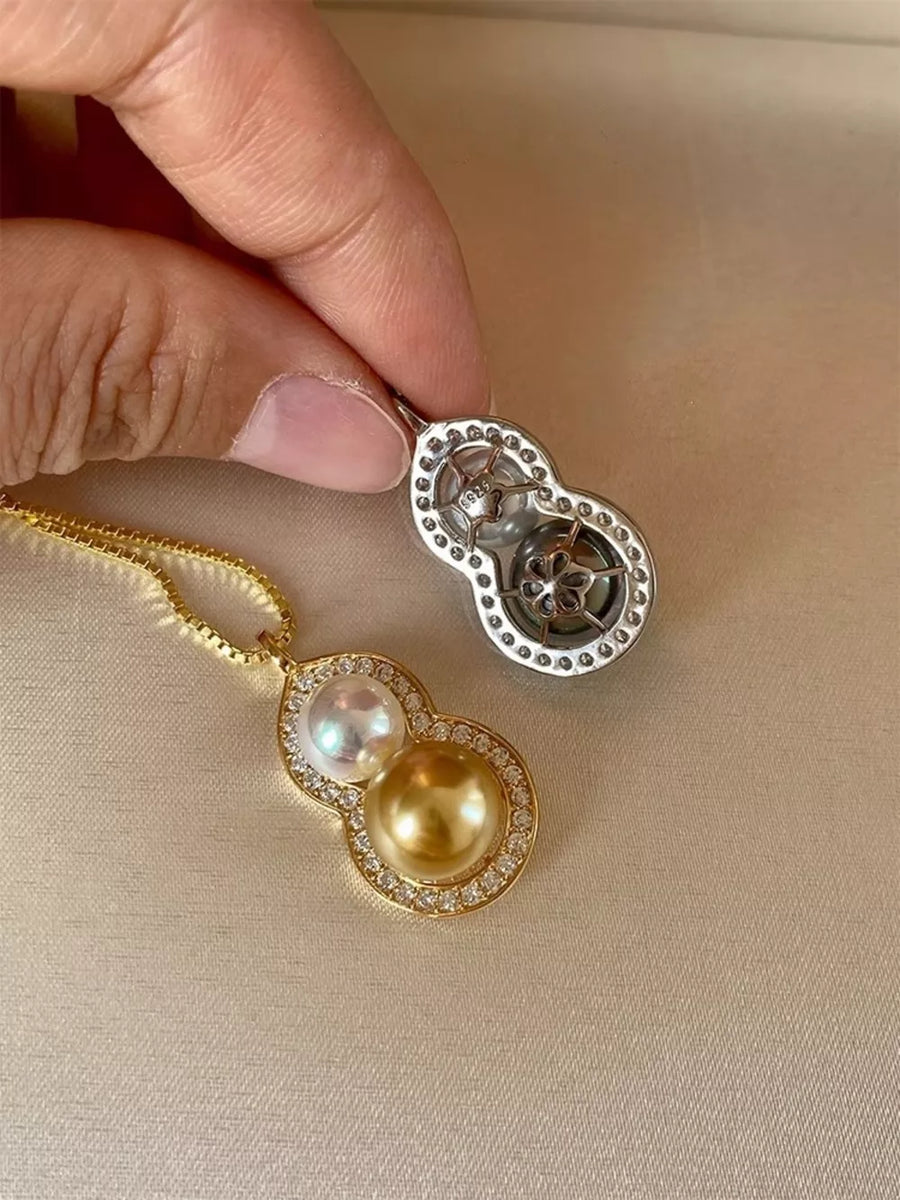 Gold gourd pendant necklace with pearls and cubic zirconia on a box chain.