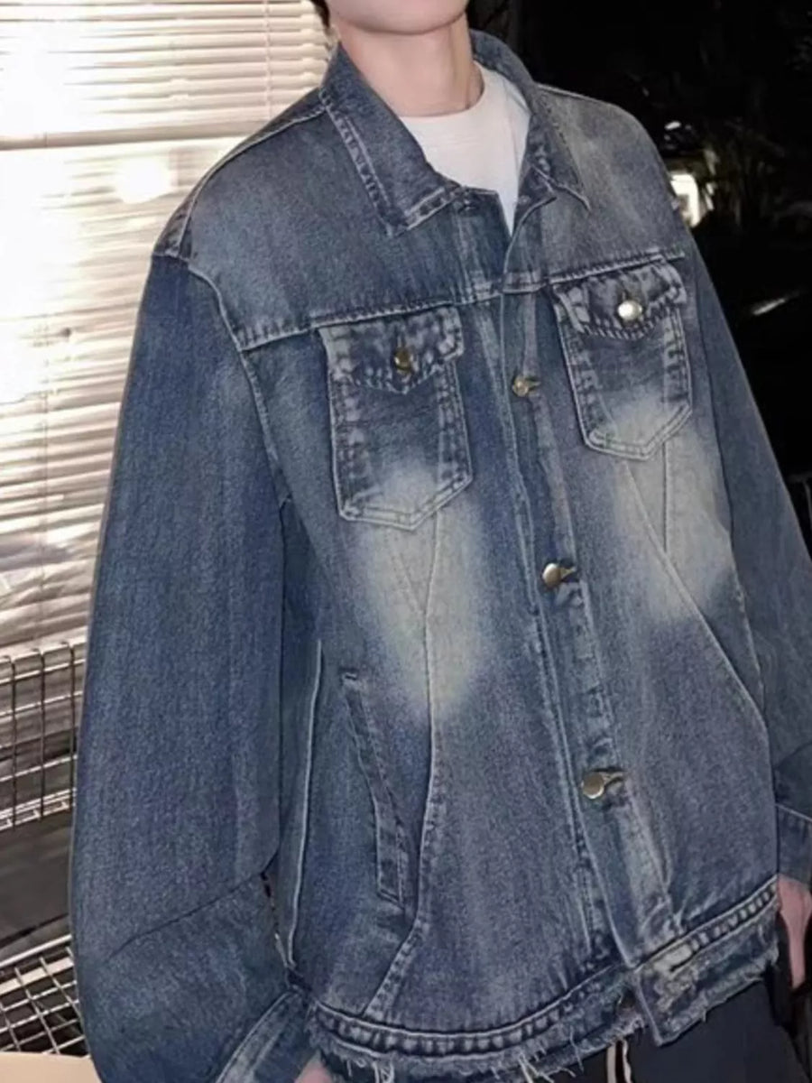Blue washed denim trucker jacket with button front and chest pockets.