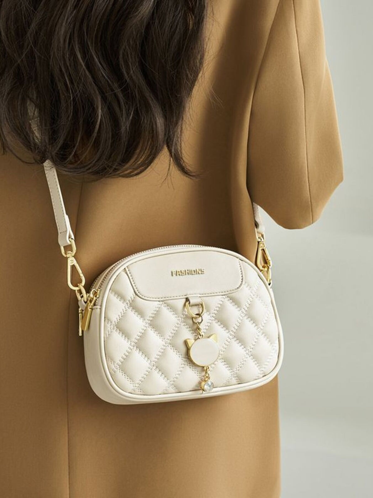 Off-white quilted PU leather crossbody bag with cat charm and gold hardware