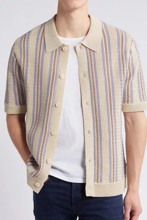 Textured knit polo shirt in tan with purple and brown stripes, short sleeves, and button front.