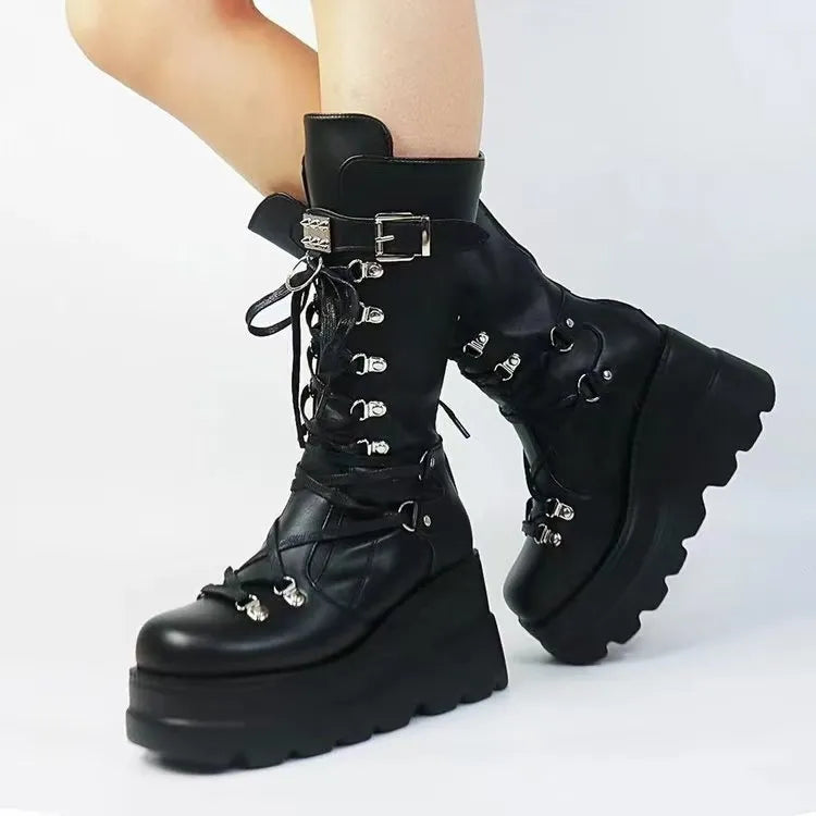 Black platform lace-up combat boots with buckle detail and lug sole.