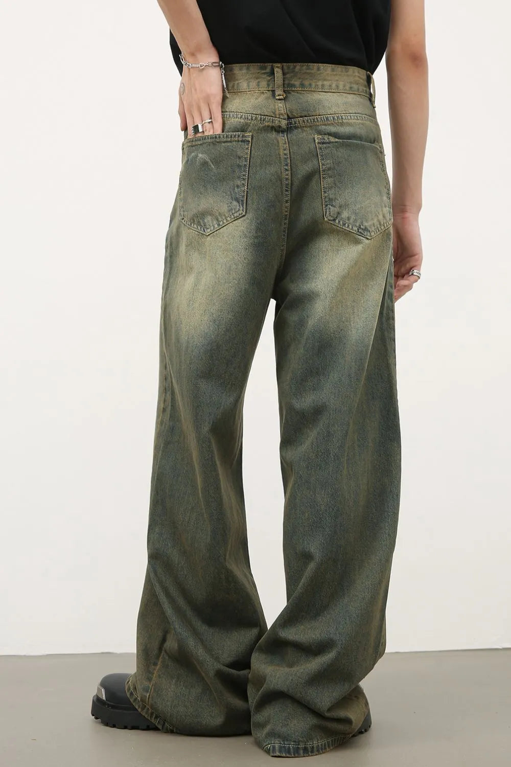 Dark wash vintage palazzo denim trousers with a wide leg and distressed details.