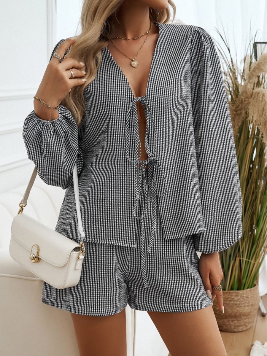 Black gingham tie-front blouse with puff sleeves and matching shorts.