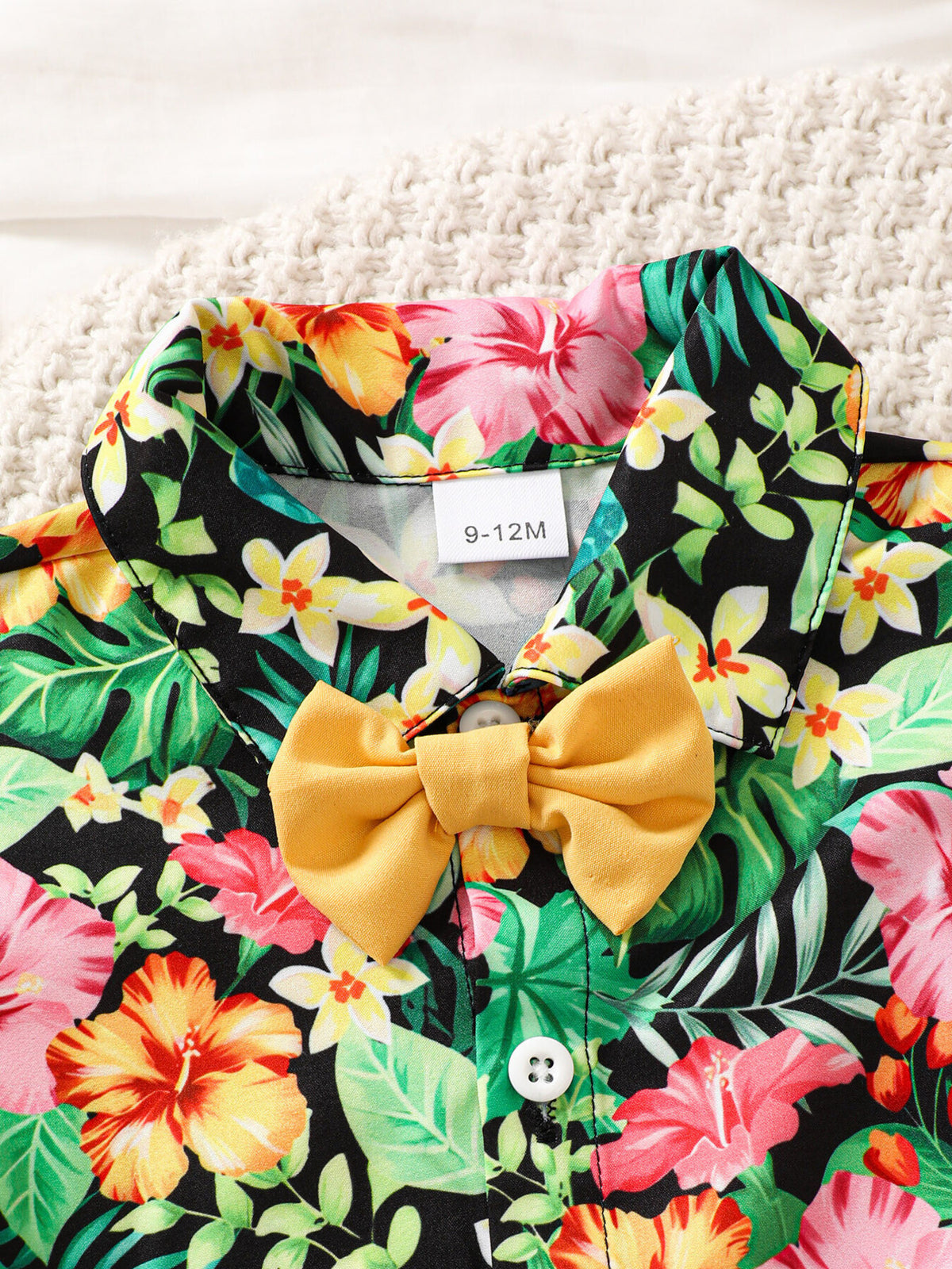 Baby boys' tropical print shirt with yellow bow tie detail.