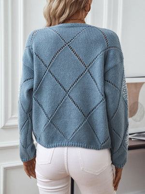 Dusty Blue diamond knit sweater with sequin detail on sleeves.