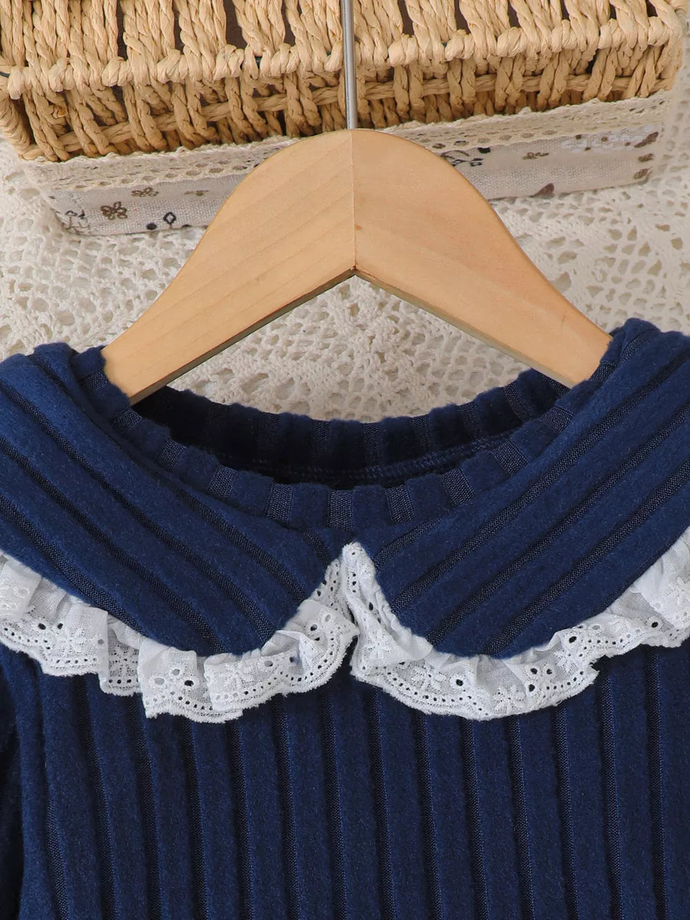 Navy ribbed knit toddler top with white lace Peter Pan collar.