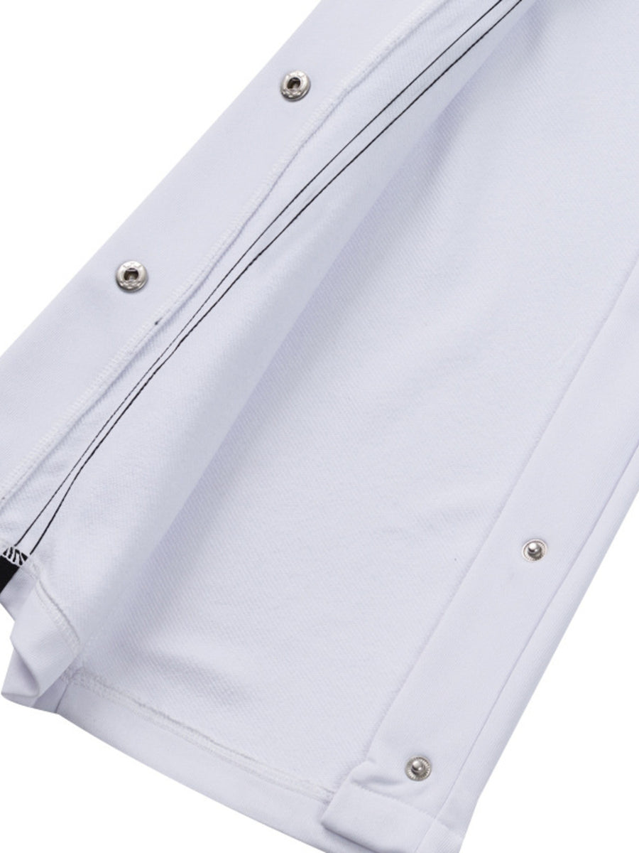 White men's track pants with snap buttons and black contrast stitching detail.