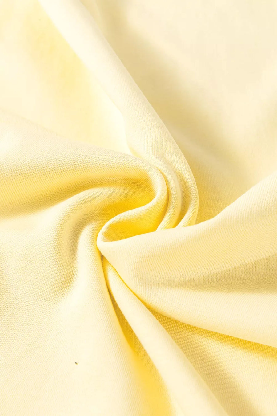 Light yellow cotton knit fabric with soft folds.