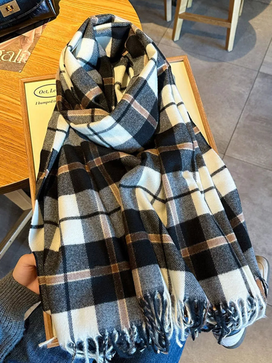 Heritage plaid scarf in black, white, and taupe with fringe detail.