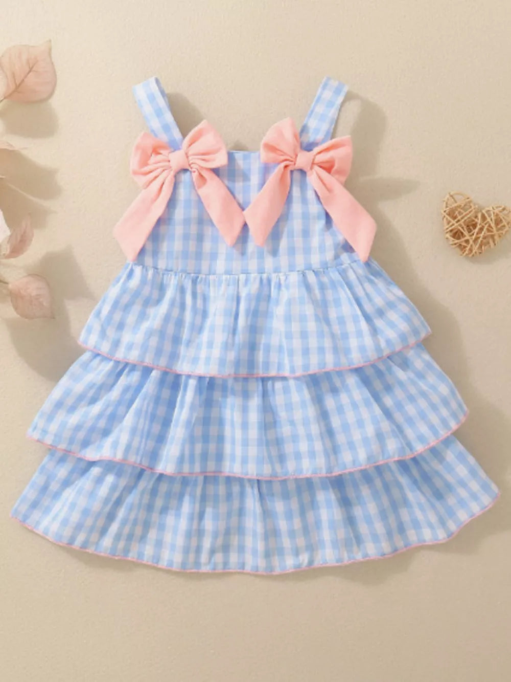 Blue gingham baby dress with pink bows and tiered skirt